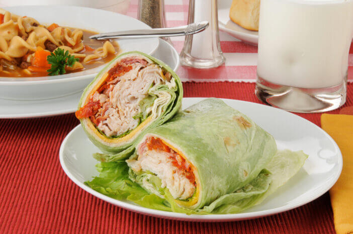 Turkey club sandwich wrapped in a spinach tortilla
