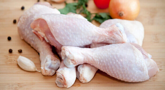 5+ Facts About Cooking Bone-in Chicken You Need to Know 1 Raw chicken legs with vegetables and spices on the chopping board