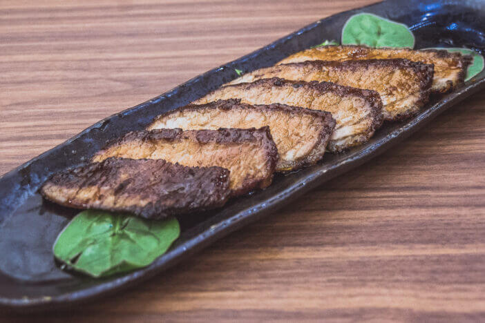 4+ Ways American Kurobuta Pork Will Elevate Your Cooking Game 3 Side dish Kurobuta Hoho Yaki Grilled Iberico Pork Jowl served on spinach leaves