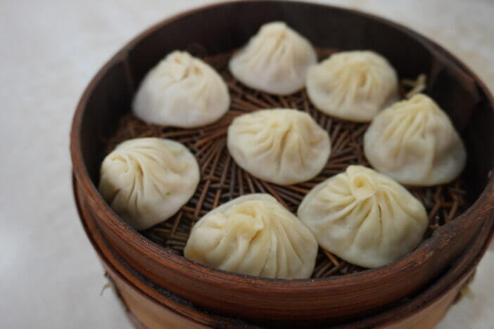 Delicious xiao long tang bao (Shanghai steamed soup dumplings). The broth-filled Shanghainese steamed pork dumplings is an iconic chinese dish in Shanghai.