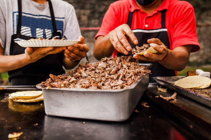 Mexican People eating tacos al pastor in Taqueria in Mexico