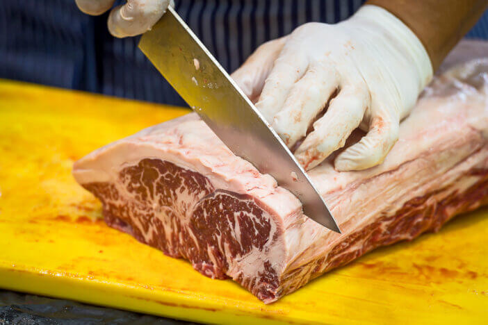 Chefs are preparing Wagyu beef for cooking.
