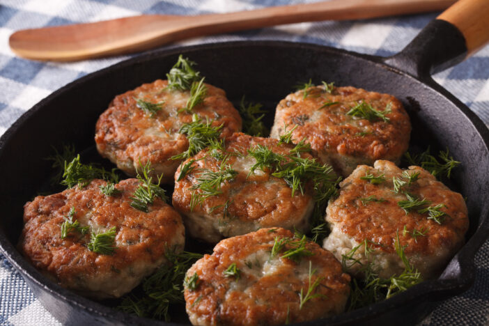 16+ Tasty Ways to Enjoy Pacific Coast Cod 3 Cooking fish cakes with herbs close-up in a pan. Horizontal