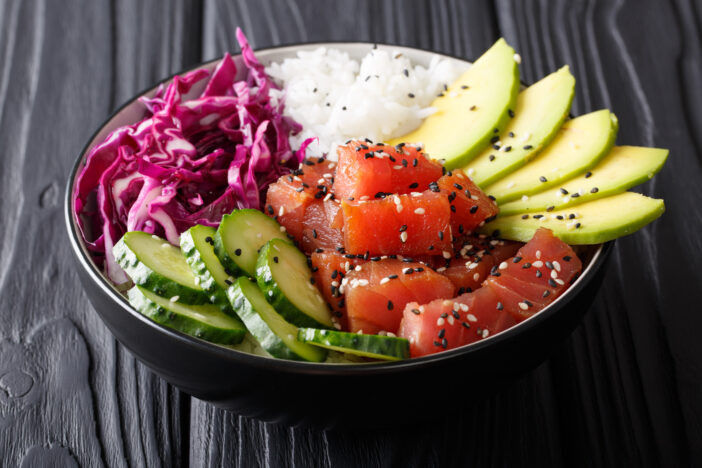 Organic food: tuna poke bowl with rice, fresh cucumbers, red cab