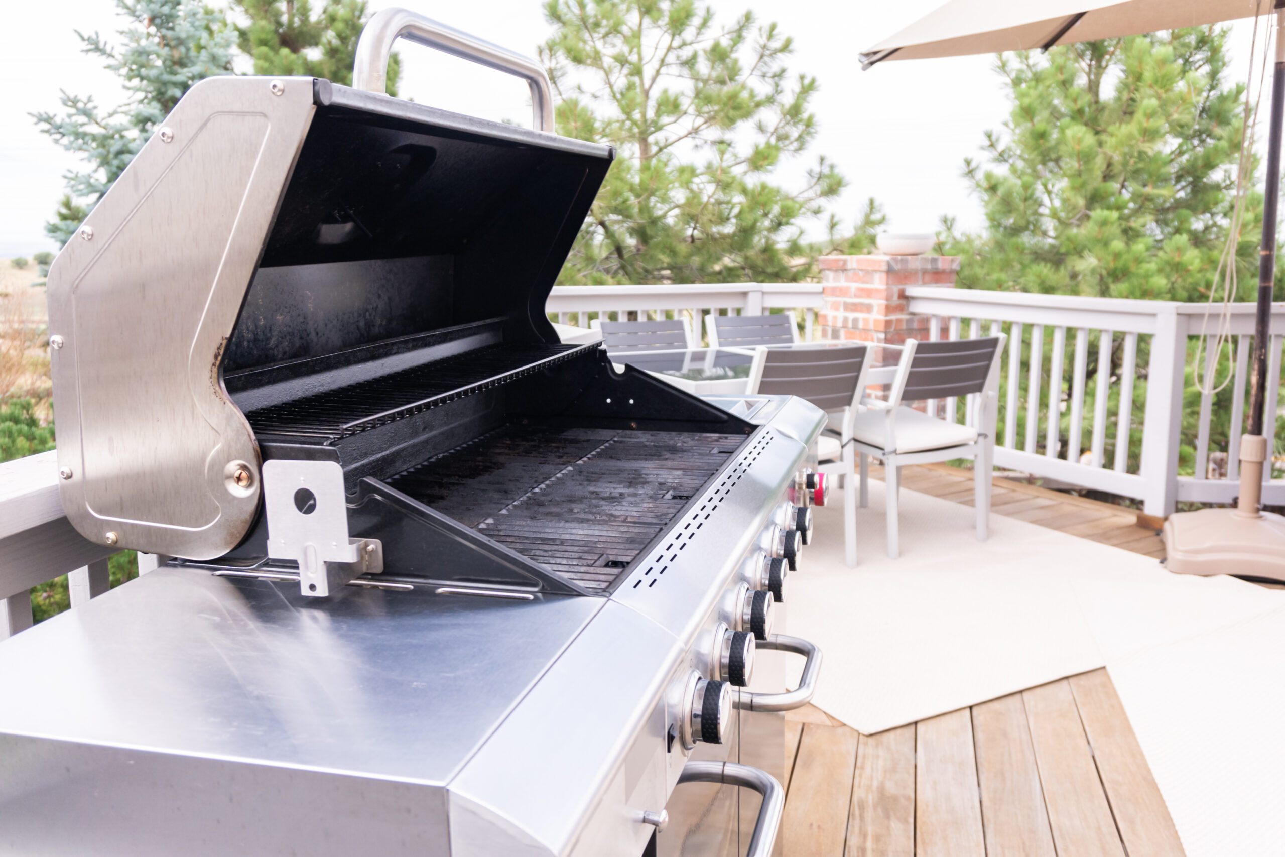 6+ Best Outdoor Griddles for a Delicious Outdoor Cookout 1 Outdoor six-burner gas grill on the back patio of a luxury single-family home.