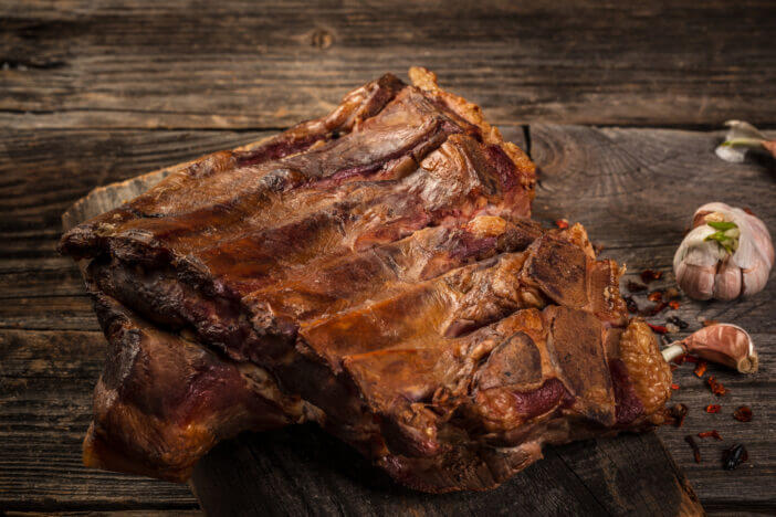 Close up homemade smoked barbecue pork ribs ready to eat. top view Food recipe background.