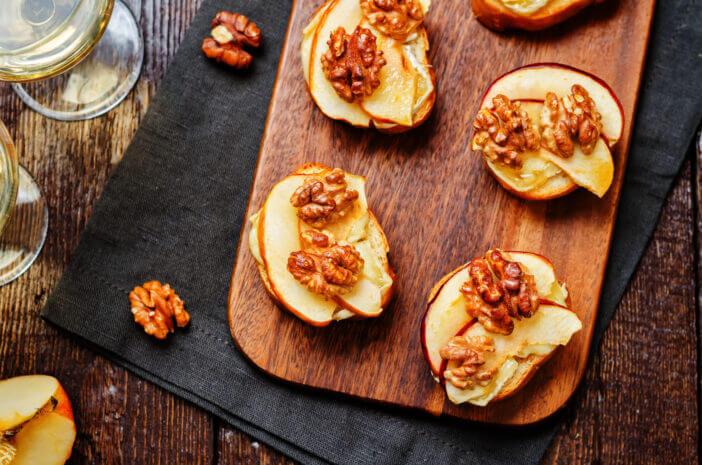 Apple Brie maple syrup walnut crostini. toning. selective focus