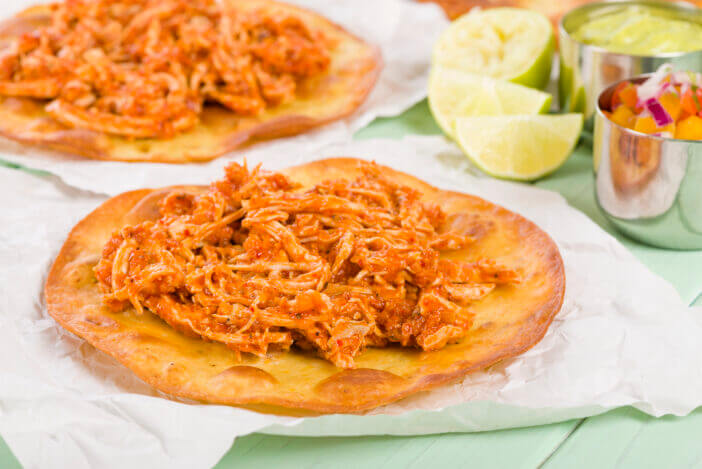 10+ Tasty Mexican Meats That Will Spice Up Your Meal 5 Mexican crispy corn tortilla topped with chicken tinga. Served with pico de gallo, guacamole and crema mexicana.