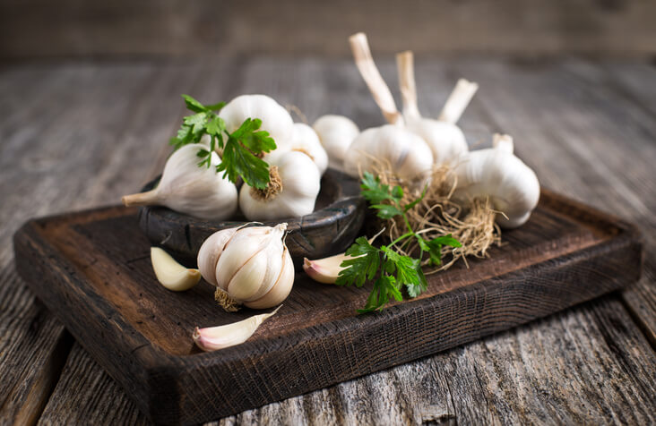 Garlic Expressions: Elevate Your Meals with This Versatile Marinade 1 Fresh organic garlic on the wooden table