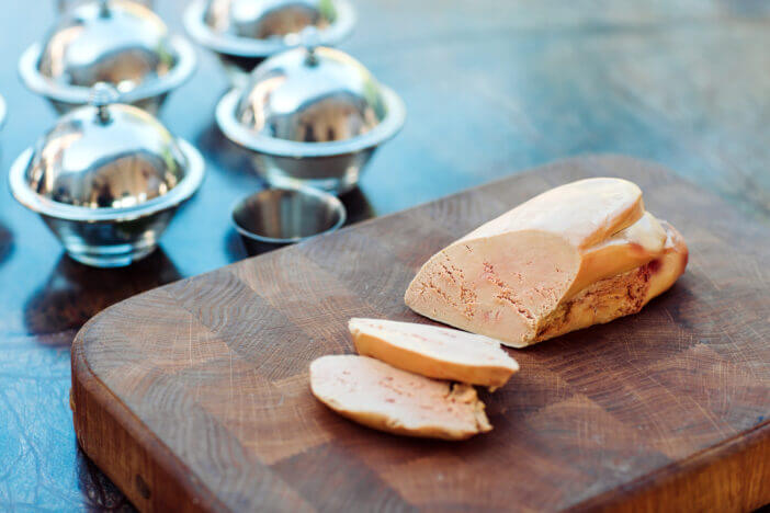 Goose liver on a wooden Board in the restaurant before cooking.