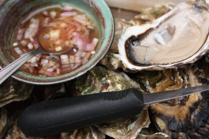 Oysters seasoned with sauce of wine vinegar and shallot Homemade sauce