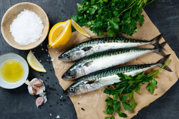 10+ Delicious Types of Fish to Try in Sashimi 5 Fresh mackerel fish on paper with lemon, salt, olive oil, garlic, parsley and pepper. Top view