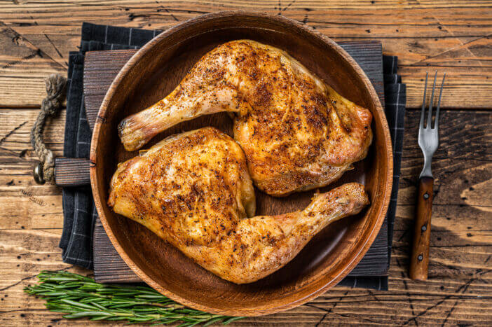 10+ Things to Know About Chicken Leg Quarters 2 BBQ Grilled chicken legs in a wooden plate with herbs. wooden background. Top view.