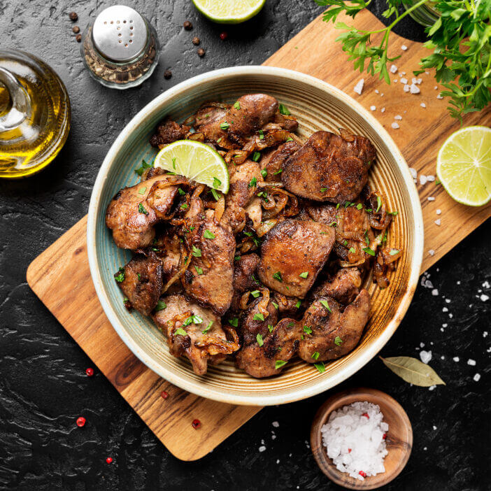 Fried chicken liver with onions and herbs. top view