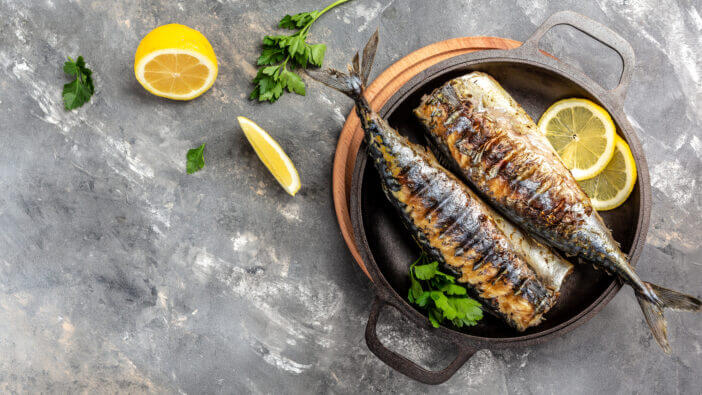 11+ Delicious Ways to Enjoy the Taste of Mackerel 2 BBQ Grilled mackerel fish with herbs. Beer Fest menu. banner, menu recipe place for text, top view.