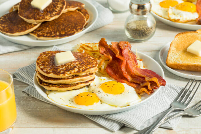 Healthy Full American Breakfast with Eggs Bacon and Pancakes