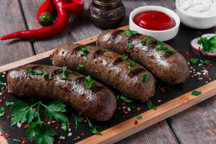 homemade cooked sausages fried on a grill beef