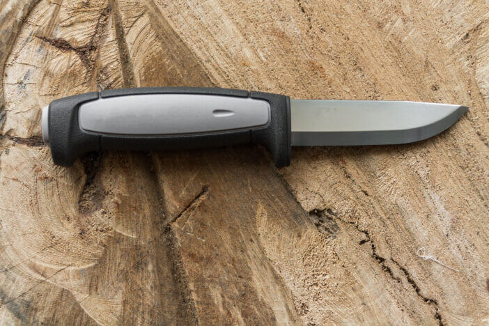 Skinning Knife. Knife for butchering venison. Knife on a wooden background.