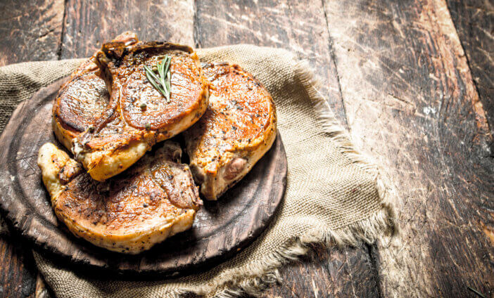 11 Premium Meat Gift Options For This Holiday Season 6 Grilled pork steak with spices. On wooden background.