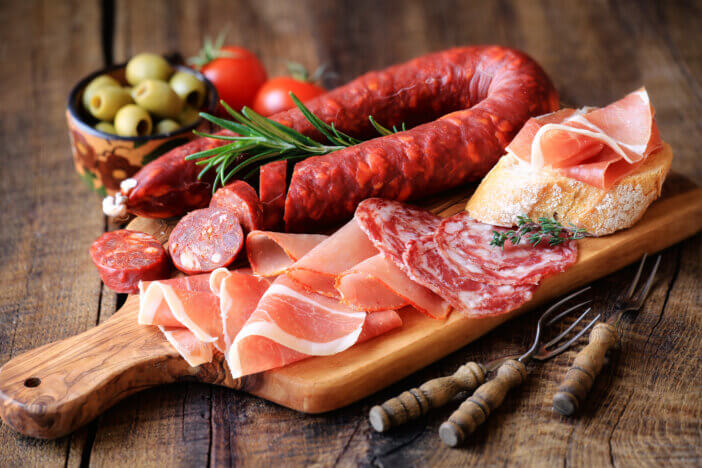 11 Special Occasion Meat Gifts For This Holiday Season 4 Cured meat platter of traditional Spanish tapas - chorizo, salsichon, jamon serrano, lomo - erved on wooden board with olives and bread