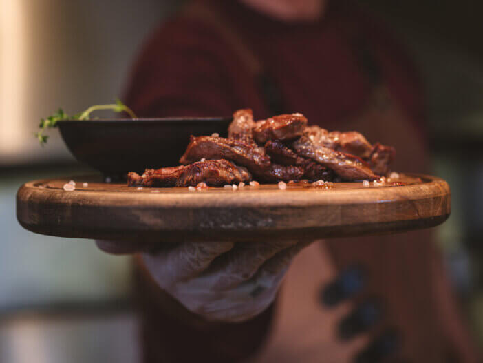 9 Gourmet Meats For Cooking For Home Chefs & Food Bloggers 5 freshly cooked veal chop on wooden plate