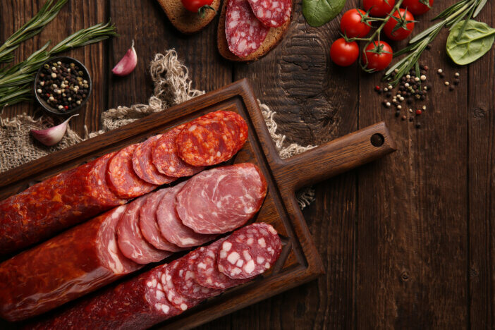 11 Gourmet Meat Gift Sets For This Holiday Season 8 Sausage and cold cuts. Types of different loaf sausages on an old wooden background and burlap with cherry tomatoes, rosemary, garlic and spices. Rustic. Top. Background image, copy space