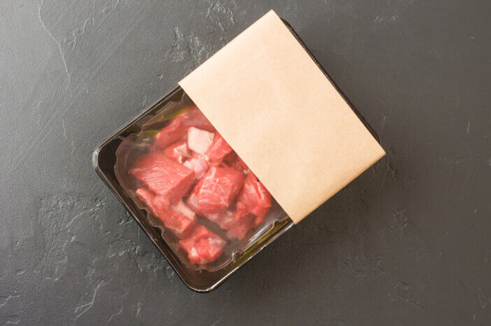 11 Special Occasion Meat Gifts For This Holiday Season 2 portioned pieces of fresh meat in vacuum packaging on a black background. top view. logo layout design. the concept of fast cooking