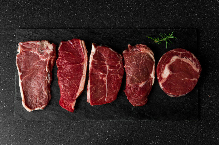 6 Grill Ready Meat Cuts For Grilling Enthusiasts 4 Selection of raw beef meat food steaks against black stone background. New york striploin steak, top blade, rib eye, and other cuts of meat.