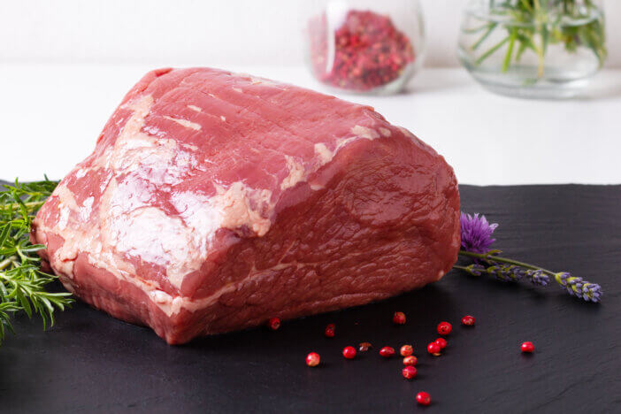 9 Lean Grass Fed Beef Cuts For Health & Fitness Enthusiasts 4 Food concept organic whole piece of raw Round beefs steak on black slate stone plate with copy space